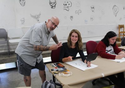 Art faculty Fred Stonehouse poses with a student in his Drawing class at the Mosse Humanities Building at the University of Wisconsin-Madison.