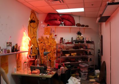 A view of a graduate studio with neon lighting in the Art Lofts.