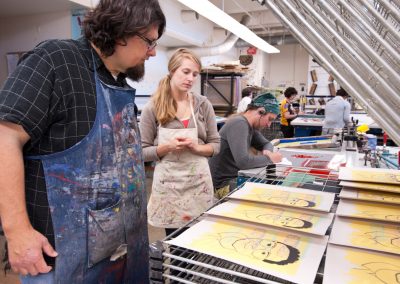 John Hitchcock reviews prints with a student in the serigraphy class in the George Mosse Humanities building at the University of Wisconsin-Madison.