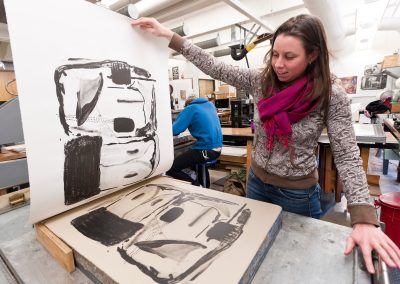A student pulls a print off a lithography stone in Lithography class at the Mosse Humanities Building at the University of Wisconsin-Madison.