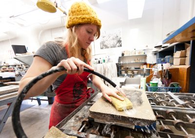 Undergraduate Olivia Baldwin washes off a lithography stone in an Art 316 Lithography class at the Mosse Humanities Building at the University of Wisconsin-Madison.