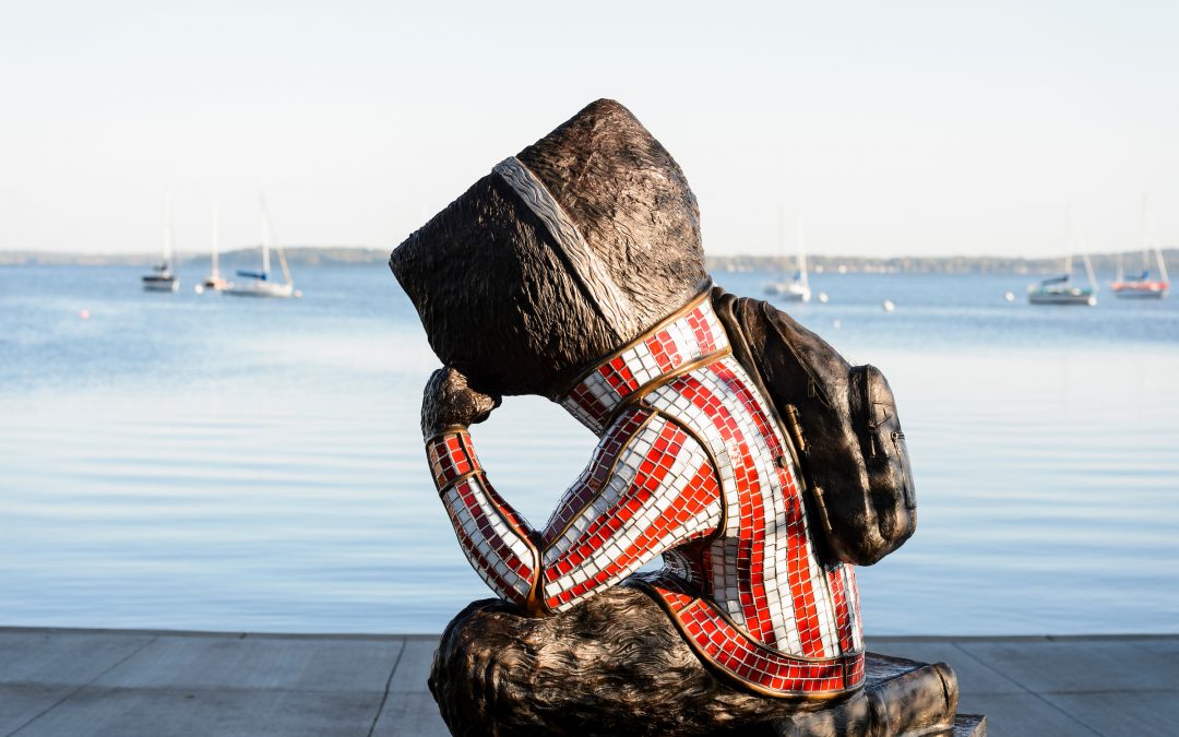 "Well Red," a sculpture by artist Douwe Blumberg of a studious-looking UW-Madison mascot Bucky Badger sitting atop a pile of books, looks out on Lake Mendota from Alumni Park at the University of Wisconsin-Madison.