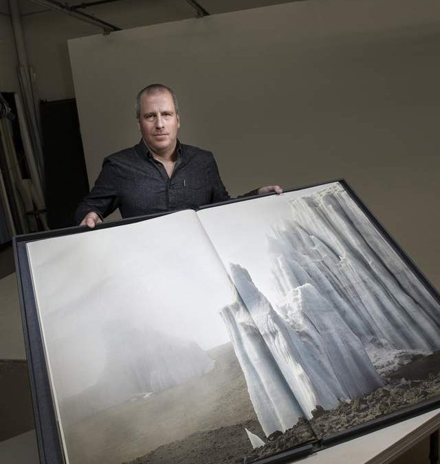 Ian Van Coller with his photography book.