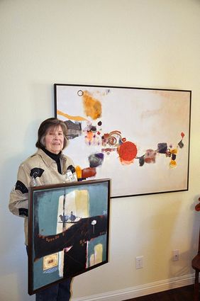 Artist Deborah Crafts displays two of her paintings; she was chosen the artist of the month by Arts Council Menifee for March.