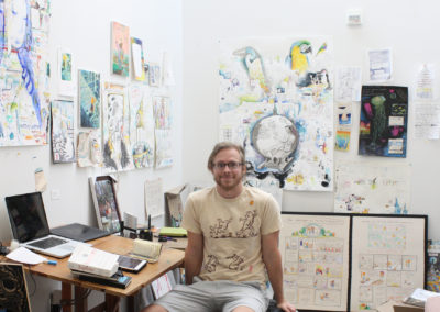 Graduate art student Will K. Santino poses with his work in his studio space in the Art Lofts building at the University of Wisconsin-Madison.