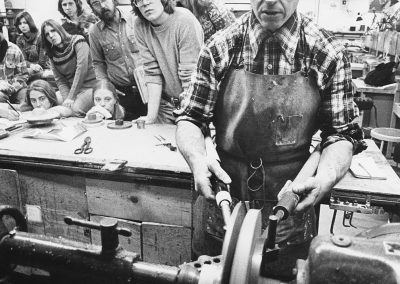 Professor Fred Fenster demonstrates metalworking techniques to his class. Fenster taught design, jewelry, and metalsmithing at the University from 1962 to 2004.