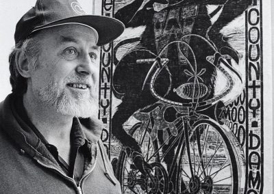 Ray Gloeckler, professor of art, poses in from of his woodcut, "Dane County Damsel," ca. 1985.