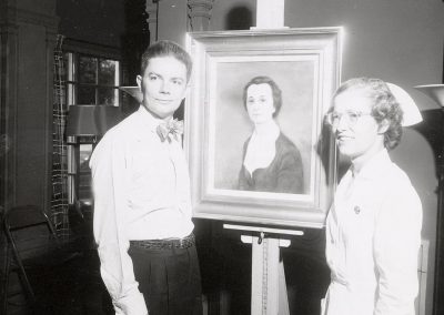 Robert Grilley poses with painting of Christina Murray, late director of UW School of Nursing. In 1942, Grilley received a Bachelor of Science degree, and in 1946 a Master of Fine Arts. He taught at the University of Wisconsin-Madison from 1945 to 1987.