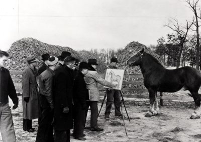 A group of students watch their instructor work on a sketch of a draft horse, ca. 1939.