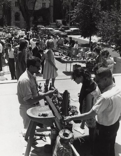 Pedestrians browse art for sale at the 1969 Library Mall Art Fair.