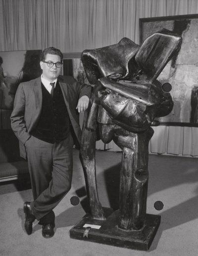 Italo Scanga stands by his sculpture for the art show at the Memorial Union, ca. 1961. Scanga taught at the University of Wisconsin-Madison from 1961 to 1964.