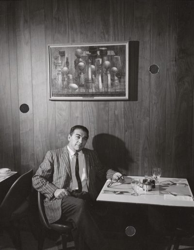 Professor Santos Zingale poses with his painting "Still Life" at the Memorial Union, ca. 1962.