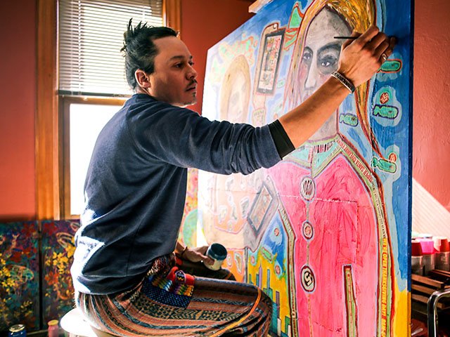 Richie Morales, one of this year's CSA artists, works on a painting.