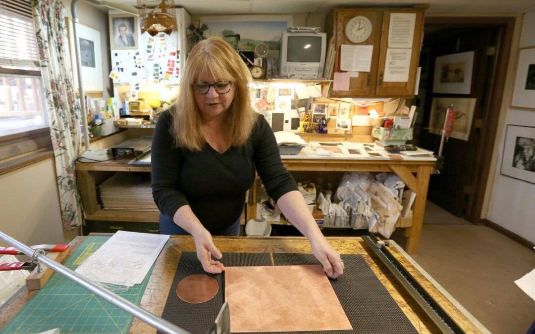 Mezzotint artist Jayne Reid Jackson shows a copper plate that she has been rocking in her studio in Madison. Rocking with a serrated tool makes burrs on the plate, which catch ink.