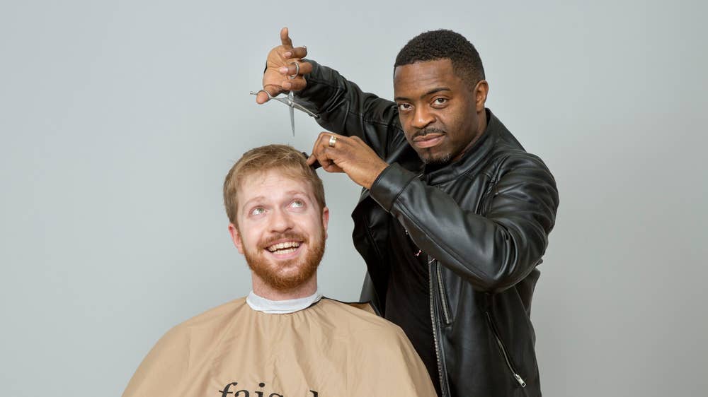 Samuel Fishwick gets a haircut from Faisal Abdu'Allah, photo by Matt Writtle