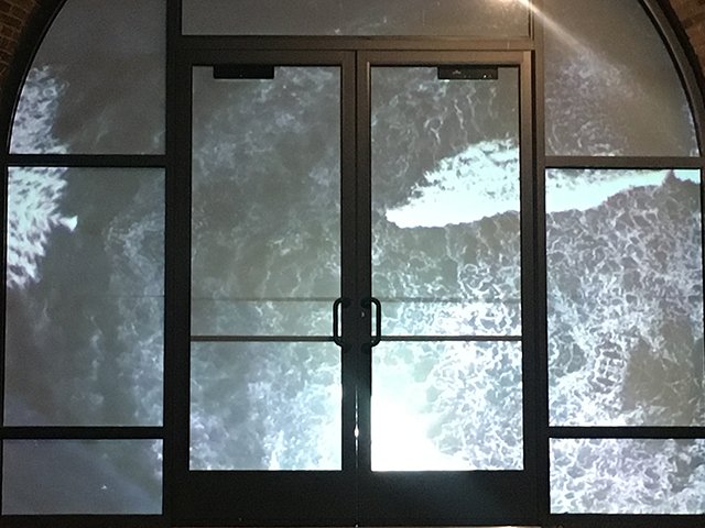 Adriana Barrios' [MFA '19] video projections frame the Garver Feed Mill entrance.