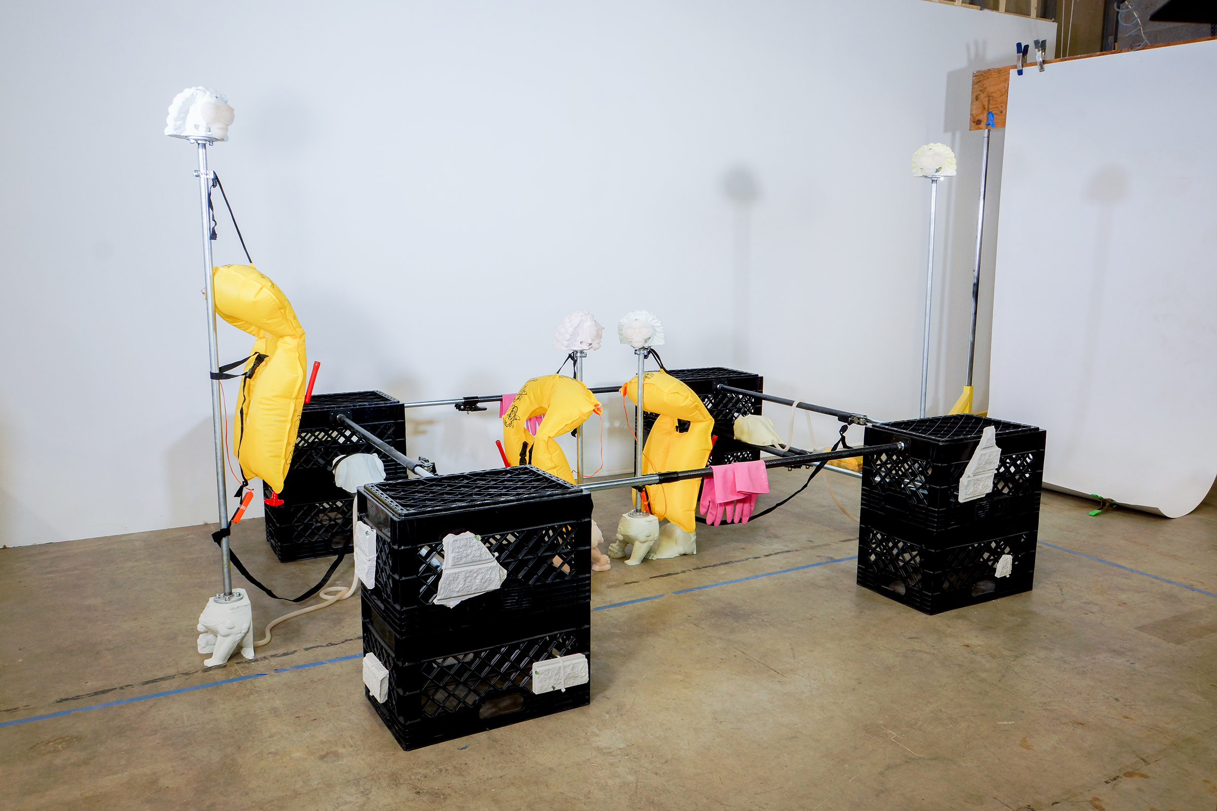 Censorium, milk crates, pigmented plaster, cargo bars, life vests, metal piping, glass marbles, silicone, rubber gloves, and zip ties by Craig Jun Li.