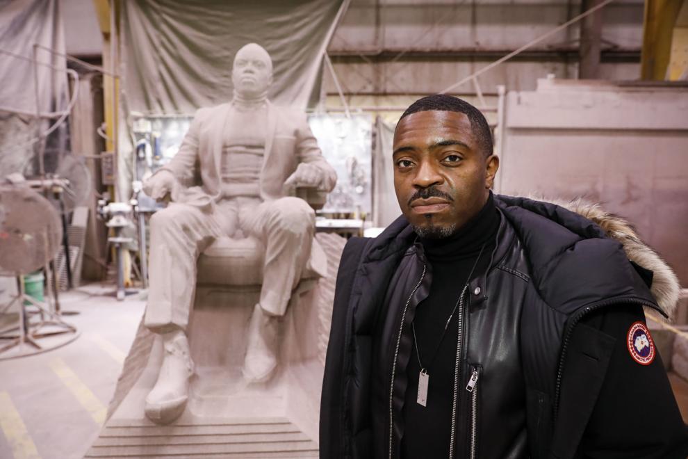 Madison artist and UW-Madison professor of printmaking Faisal Abdu'Allah is pictured with the new sculpture of himself at Quarra Stone Company in Madison. The sculpture was commissioned the Madison Museum of Contemporary Art and created by Italian sculptor Martin Foot.