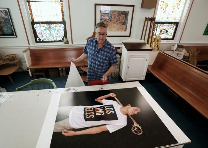 Artist and UW-Madison photography professor Tom Jones examines a portrait he will embellish with traditional Ho-Chunk beadwork at his home, a former church in Prairie du Sac. AMBER ARNOLD, STATE JOURNAL