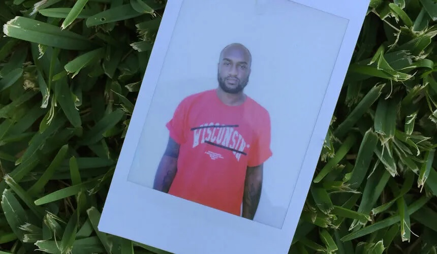 Polaroid photo of Virgil Abloh wearing a University of Wisconsin Red Shirt™ of his #OffWisconsin screenprint.