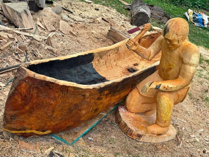Gene Delcourt created the "Dugout" installation at Merrill Spring as a sculpture of a Ho-Chunk man crafting a dugout canoe along the shore of Lake Mendota.