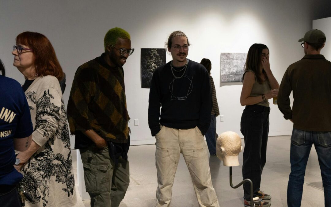 Attendees view art on display at Moonlighters art department staff exhibition on Thursday, Sept. 24, 2026. Photo by Yoonjeong Sim of The Daily Cardinal.