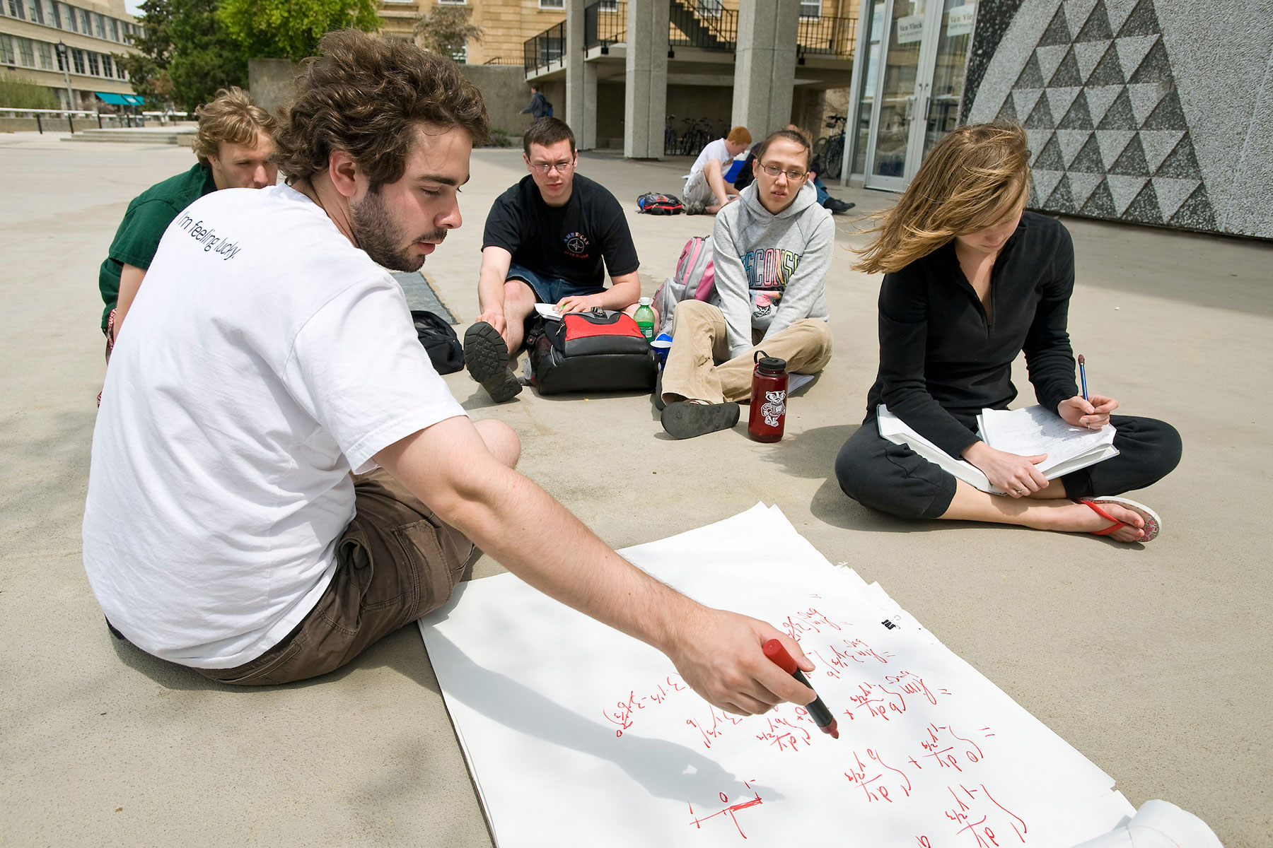 Students studying math on the sidewalk