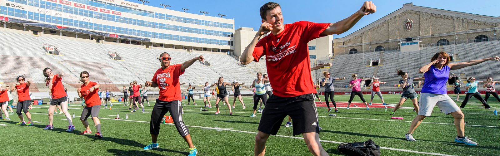 Participants in Bucky's Workout at Camp Randall Stadium doing a guided exercise routine