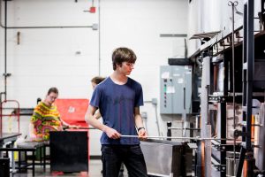 Summer Arts Studio participant works in the hot shop