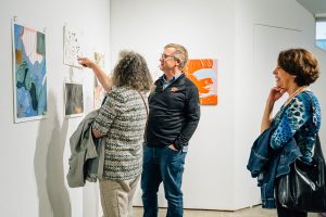 Summer Arts Studio participant sharing work in the gallery with visitors