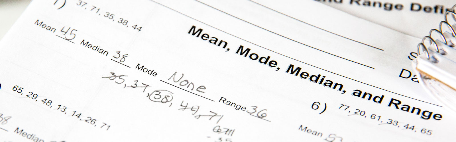 Close-up of a math worksheet on mean, median, mode, and range