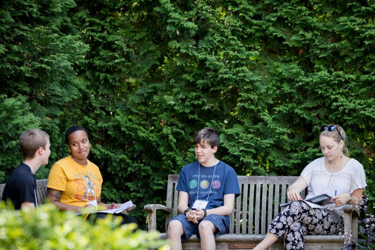 Four students discussing at highschool writers camp