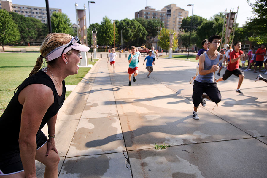 Coach leading runners