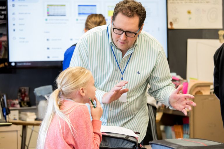 Student teacher in classroom with a young child